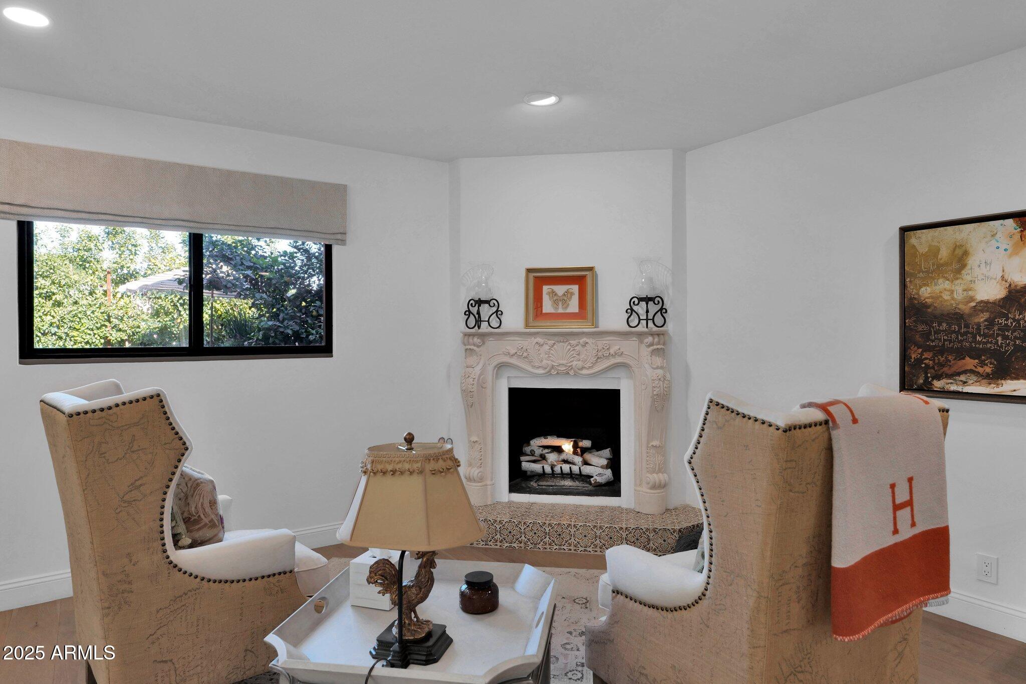6701 North Scottsdale Road, Unit 24 Scottsdale, AZ 85250 - Photo 14 of 37 a living room with furniture a window and a fireplace