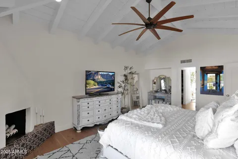 a bedroom with a bed and a television in it