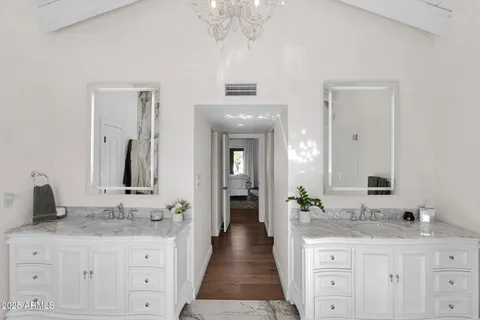 a bathroom with a granite countertop sink a large mirror and a