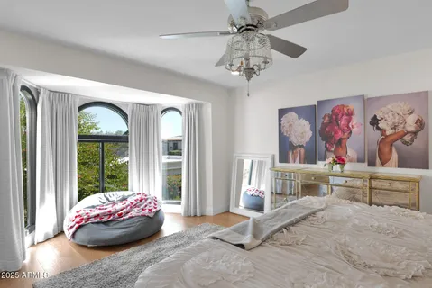a bedroom with a large bed and a chandelier