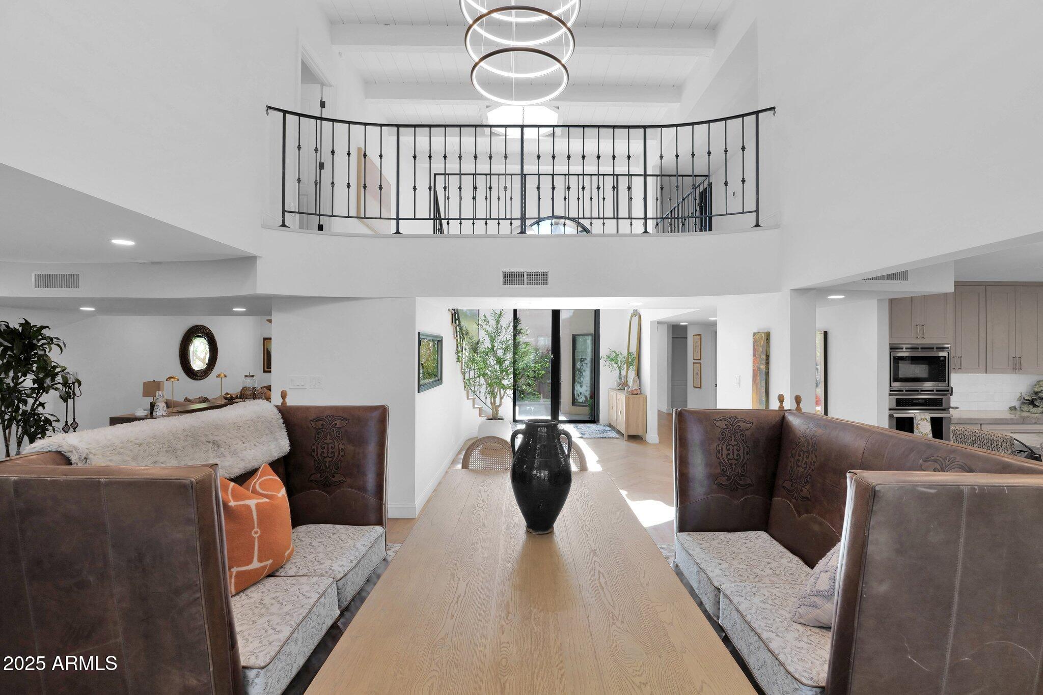 6701 North Scottsdale Road, Unit 24 Scottsdale, AZ 85250 - Photo 4 of 37 a living room with furniture a window and a chandelier