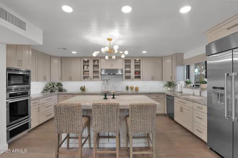 a kitchen with appliances a sink and cabinets