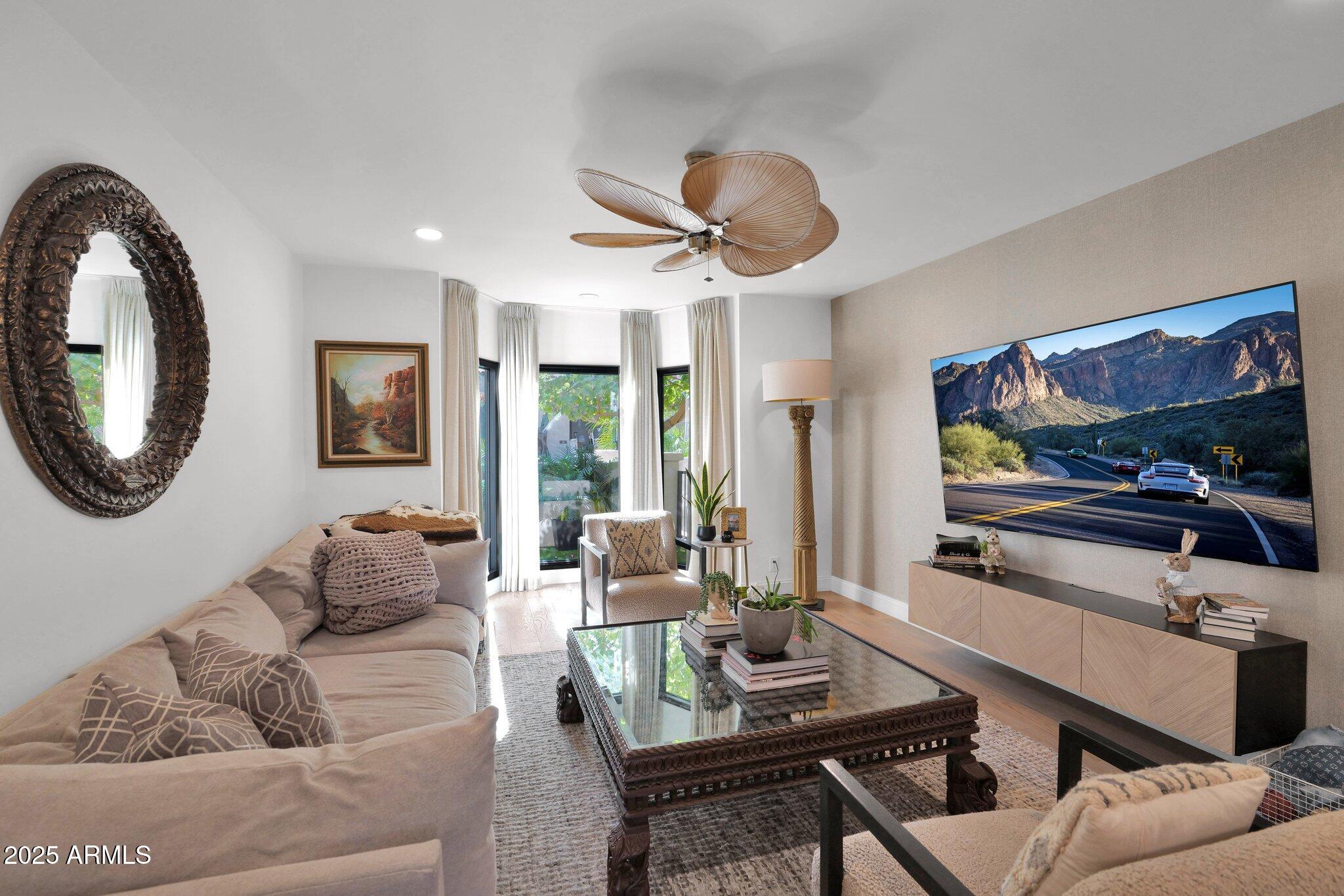 6701 North Scottsdale Road, Unit 24 Scottsdale, AZ 85250 - Photo 10 of 37 a living room with furniture and a large mirror