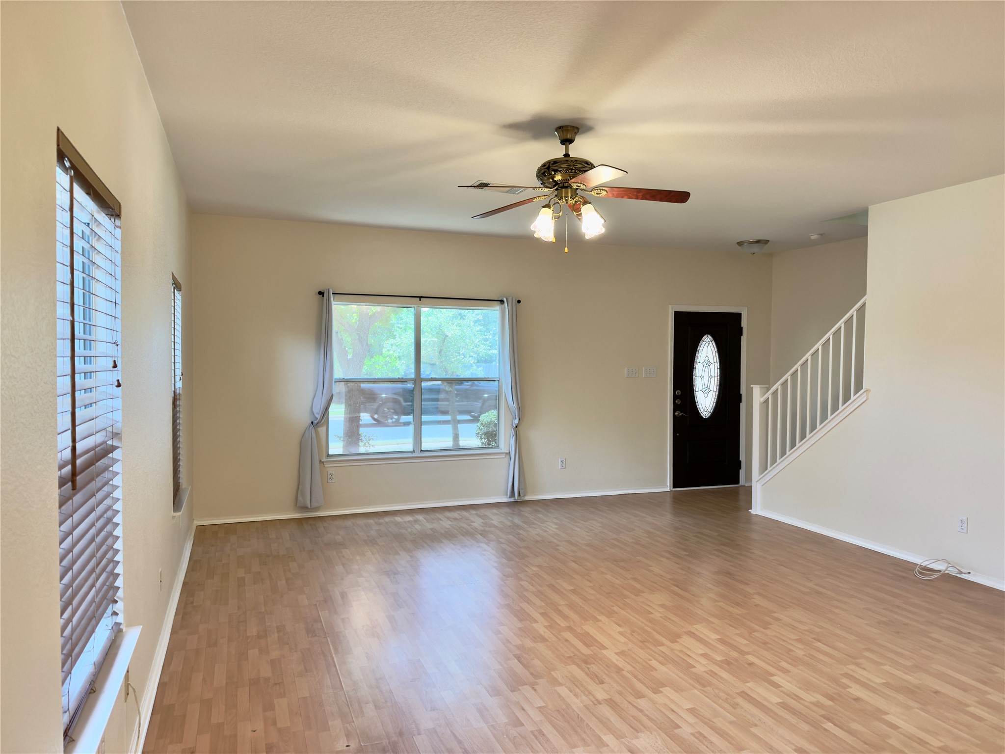1206 Devil Ridge Cedar Park, TX 78613 - Photo 12 of 38 a view of an empty room with a window and wooden floor