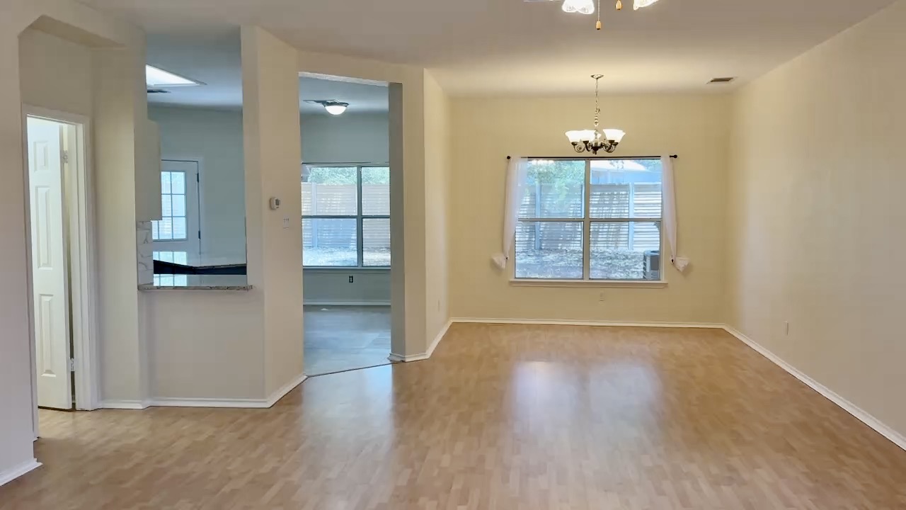 1206 Devil Ridge Cedar Park, TX 78613 - Photo 15 of 38 Unfurnished dining area featuring wood finished floors, a chandelier, and ceiling fan