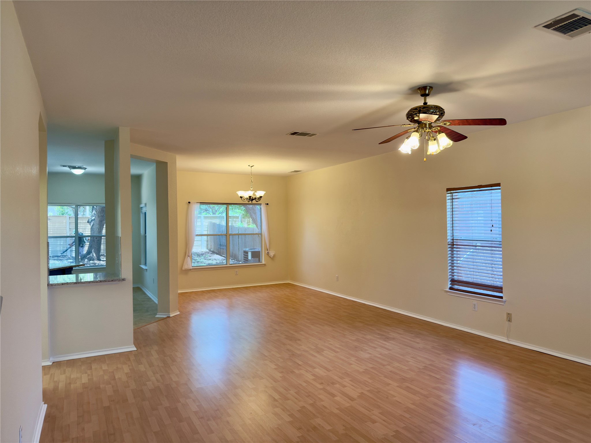 1206 Devil Ridge Cedar Park, TX 78613 - Photo 16 of 38 a view of an empty room with a window and wooden floor