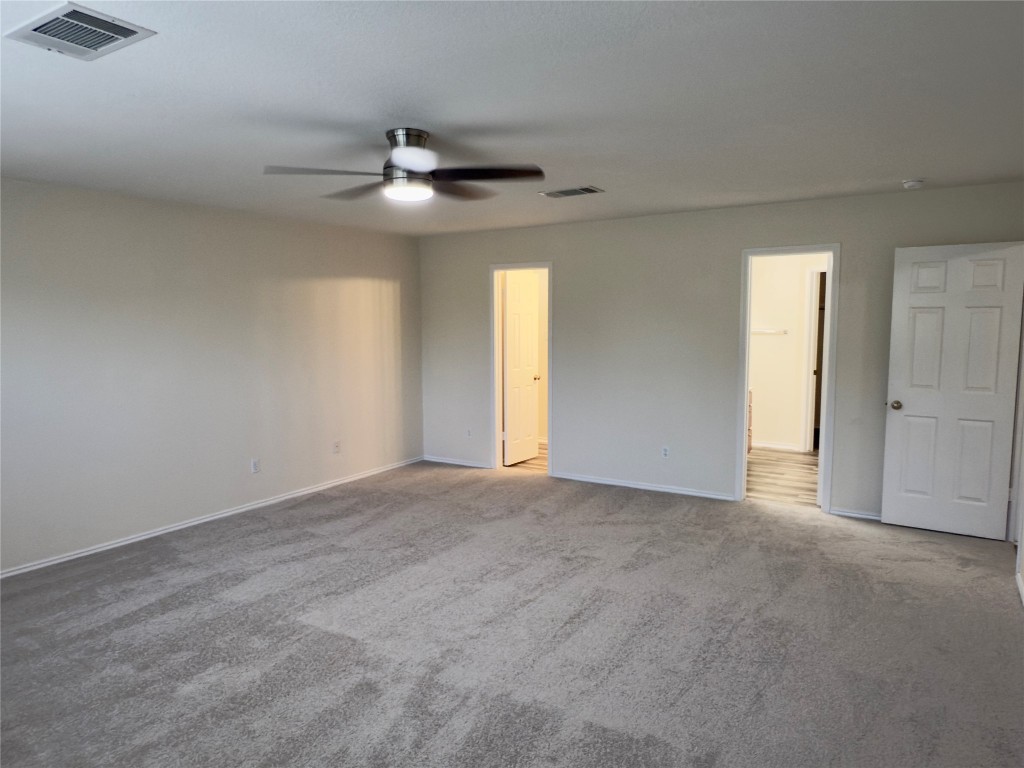 1206 Devil Ridge Cedar Park, TX 78613 - Photo 20 of 38 Empty room with ceiling fan and carpet flooring