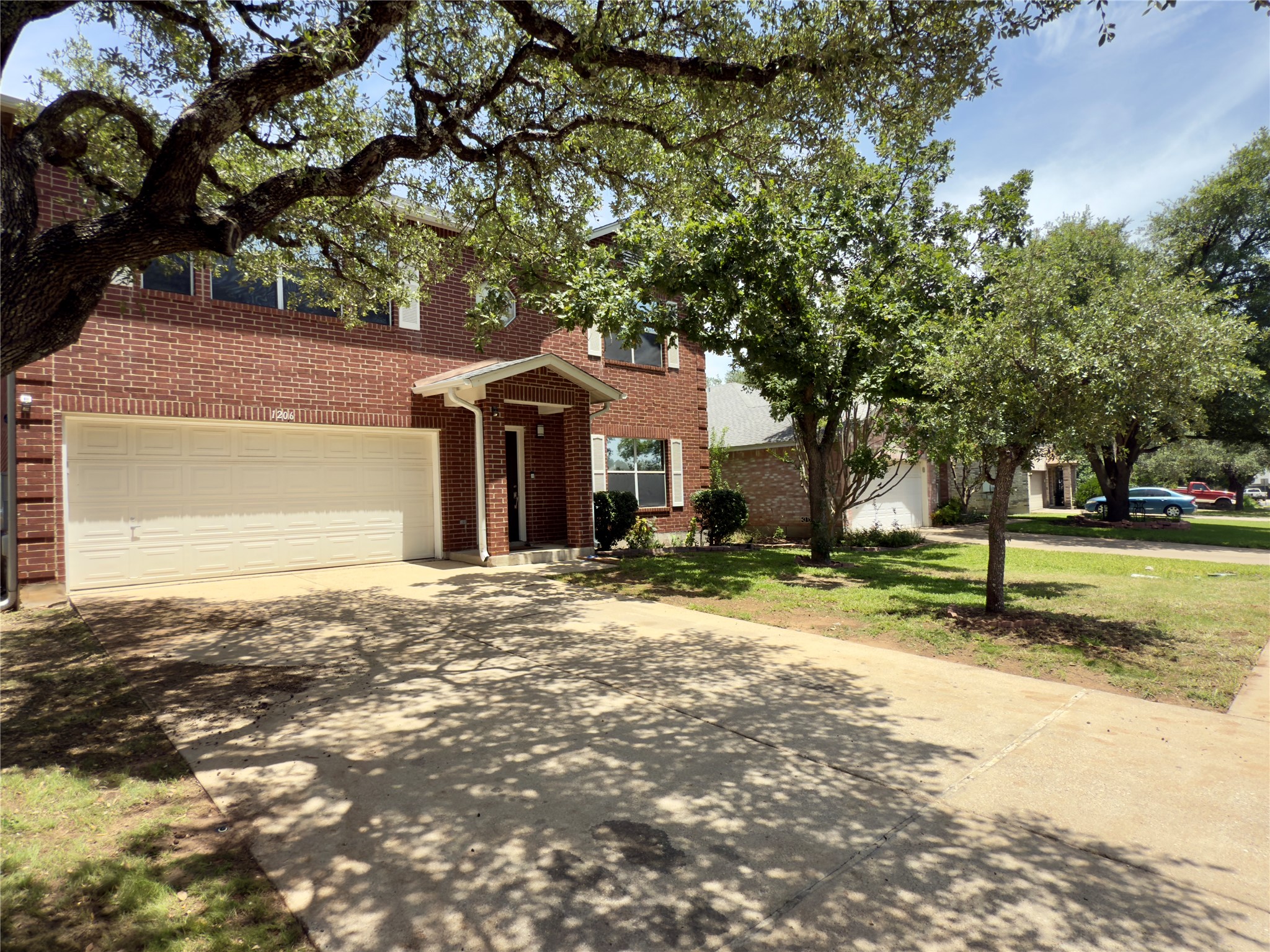 1206 Devil Ridge Cedar Park, TX 78613 - Photo 2 of 38 a front view of a house with a yard garage and trees