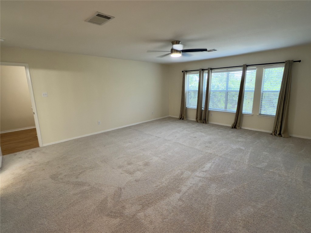 1206 Devil Ridge Cedar Park, TX 78613 - Photo 21 of 38 Carpeted spare room with ceiling fan and baseboards