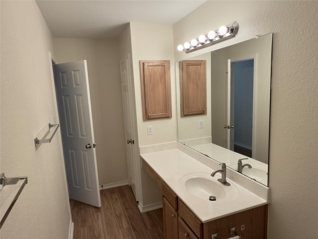 1206 Devil Ridge Cedar Park, TX 78613 - Photo 22 of 38 Bathroom with wood finished floors and vanity