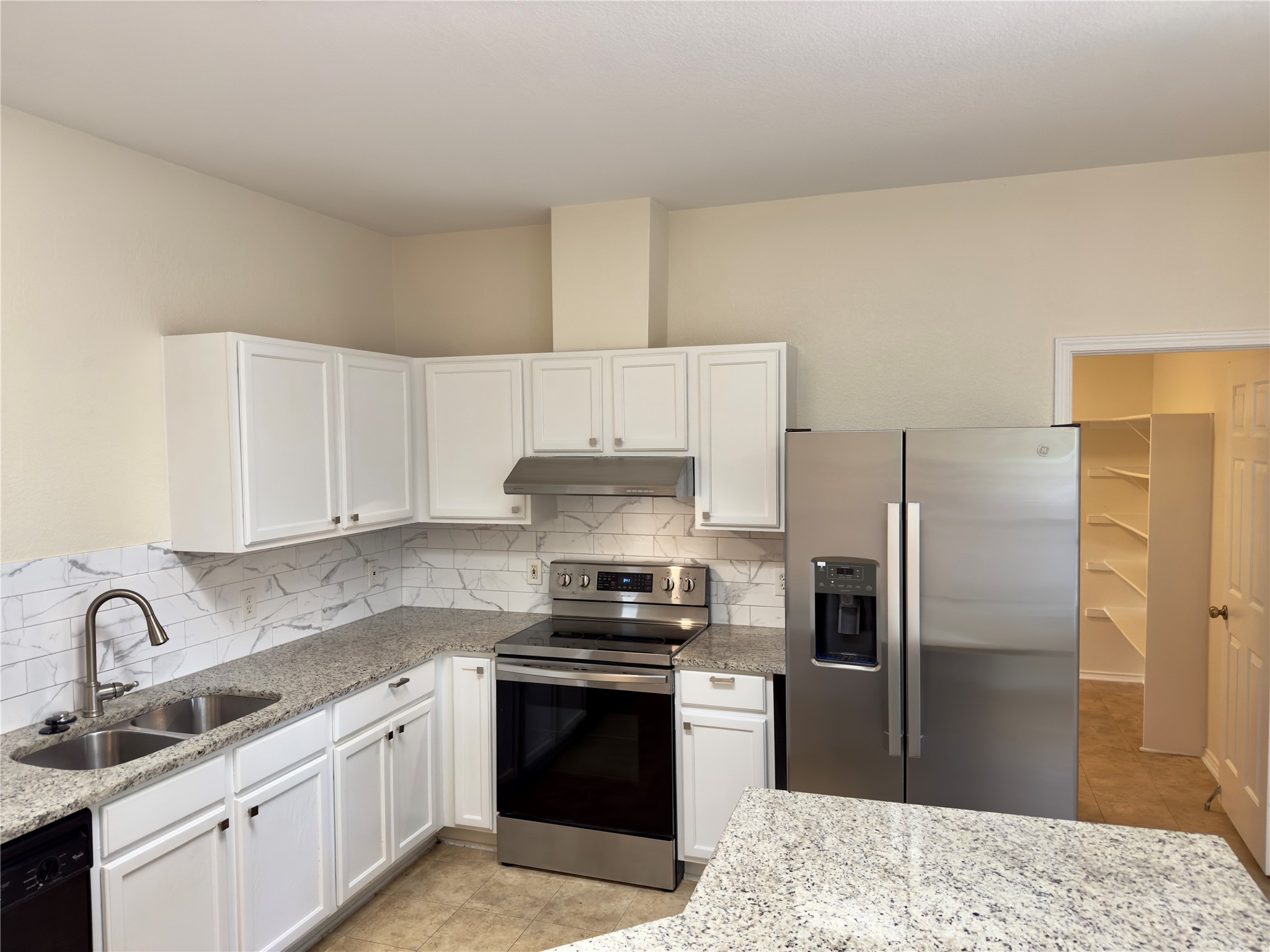 1206 Devil Ridge Cedar Park, TX 78613 - Photo 4 of 38 a kitchen with a refrigerator sink and stainless steel appliances