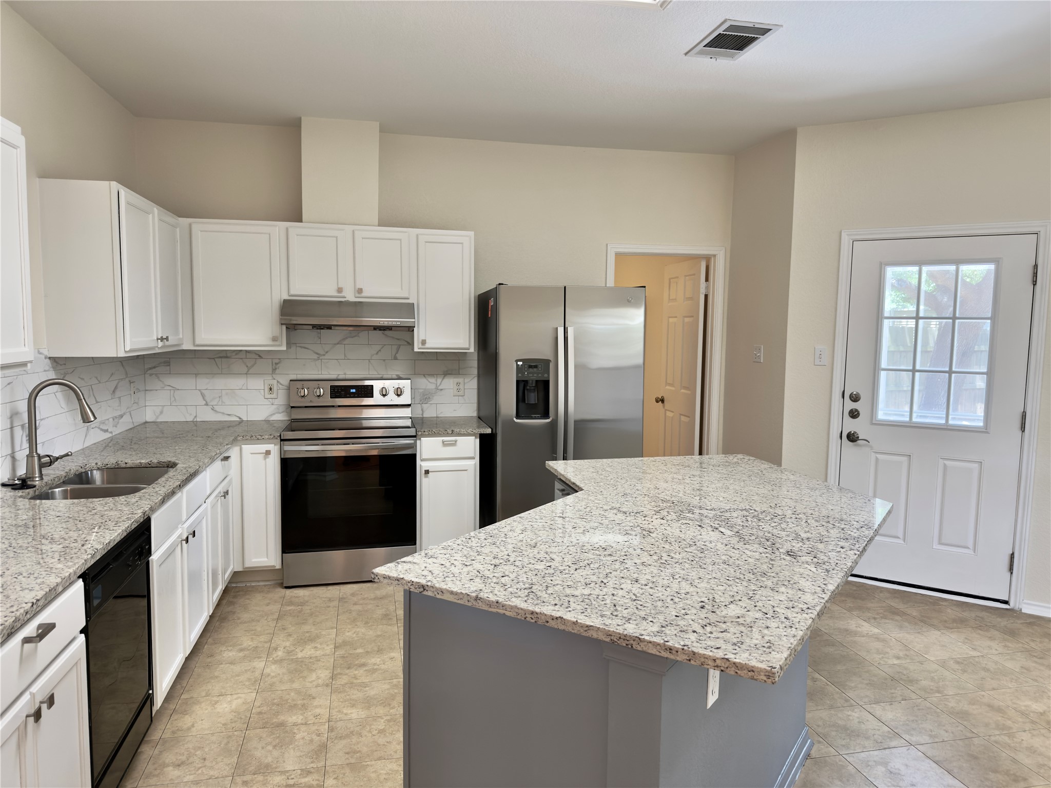 1206 Devil Ridge Cedar Park, TX 78613 - Photo 5 of 38 a kitchen with stainless steel appliances granite countertop a sink stove and refrigerator