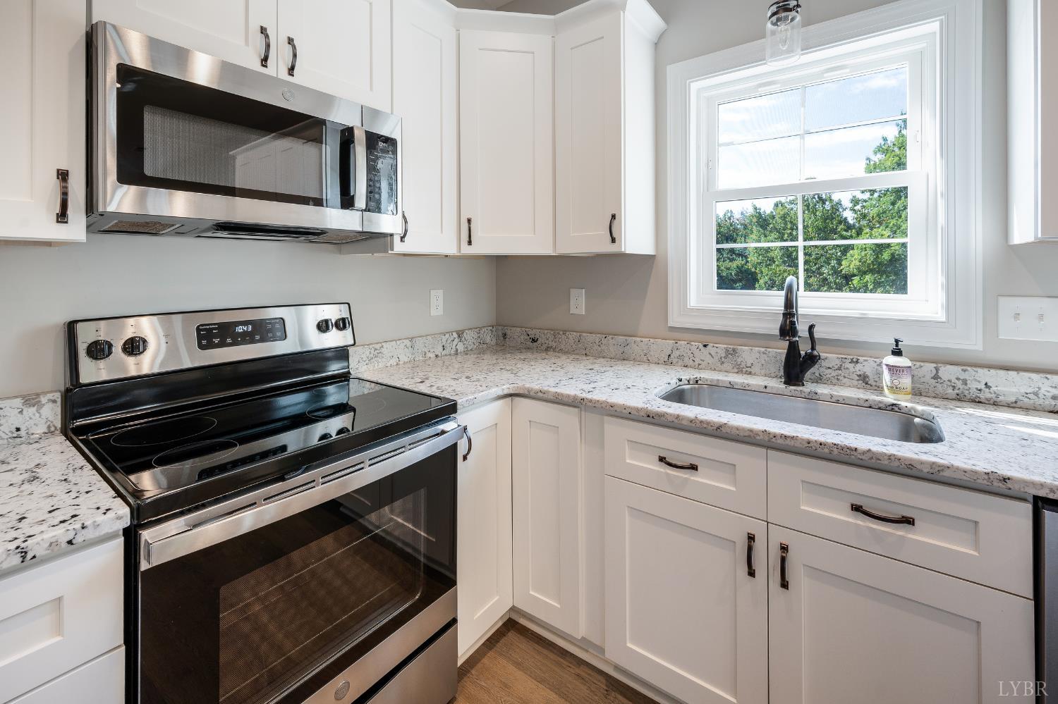 1200 Founding Way Road Bedford, VA 24523 - Photo 15 of 36 a kitchen with white cabinets stainless steel appliances and a sink