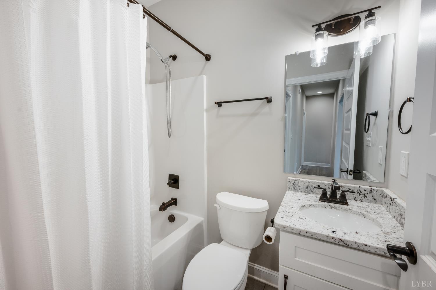 1200 Founding Way Road Bedford, VA 24523 - Photo 25 of 36 a bathroom with a granite countertop sink toilet and shower
