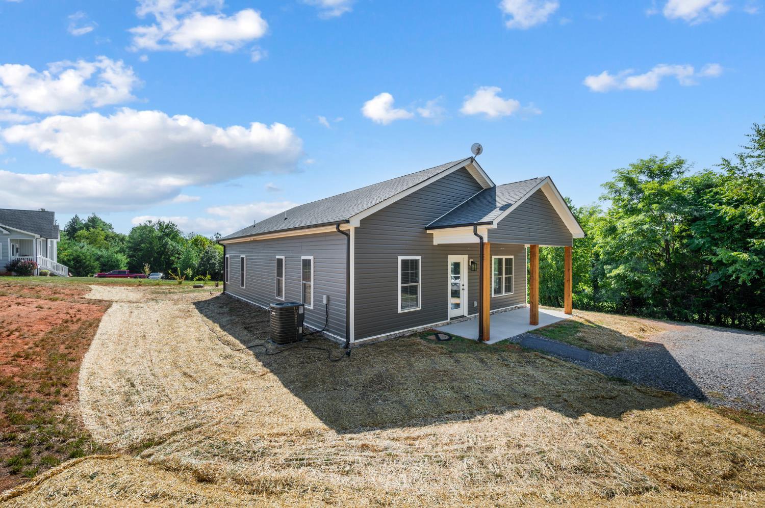 1200 Founding Way Road Bedford, VA 24523 - Photo 5 of 36 a front view of a house with a yard and garage