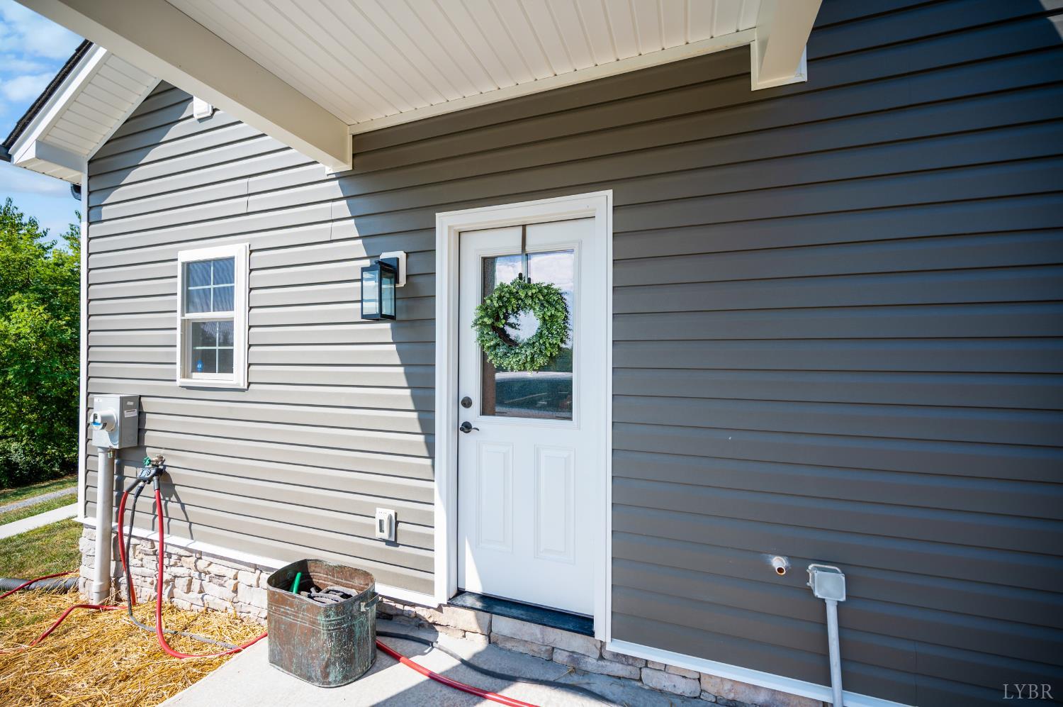 1200 Founding Way Road Bedford, VA 24523 - Photo 6 of 36 a potted plant sitting in front of a house