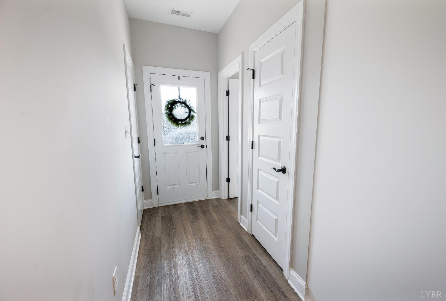 1200 Founding Way Road Bedford, VA 24523 - Photo 10 of 36 a view of a hallway with wooden floor and a bathroom