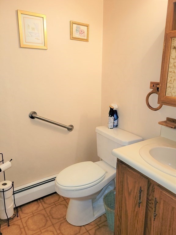 69 Fuller Street, Unit 69 Boston, MA 02124 - Photo 12 of 18 a white toilet sitting next to a bathroom sink