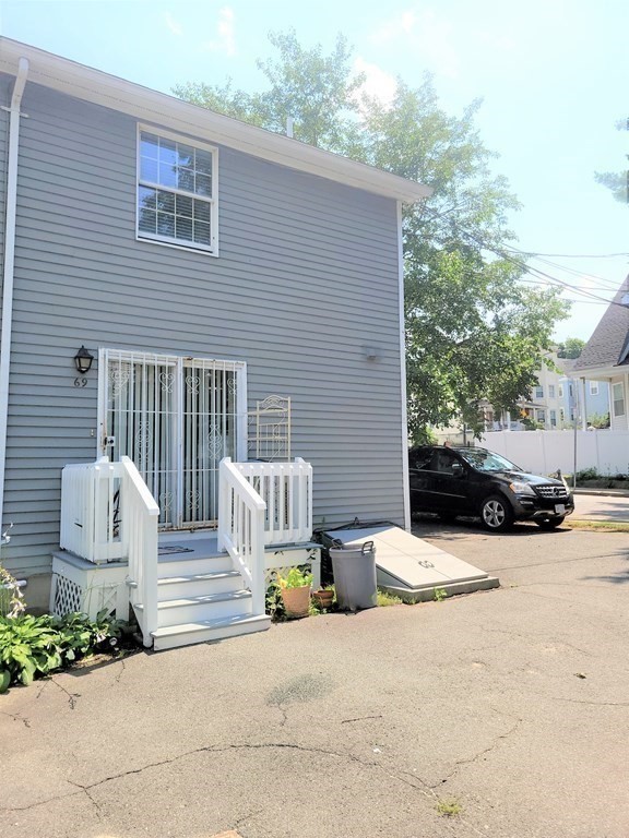 69 Fuller Street, Unit 69 Boston, MA 02124 - Photo 13 of 18 a view of street with a car parked beside