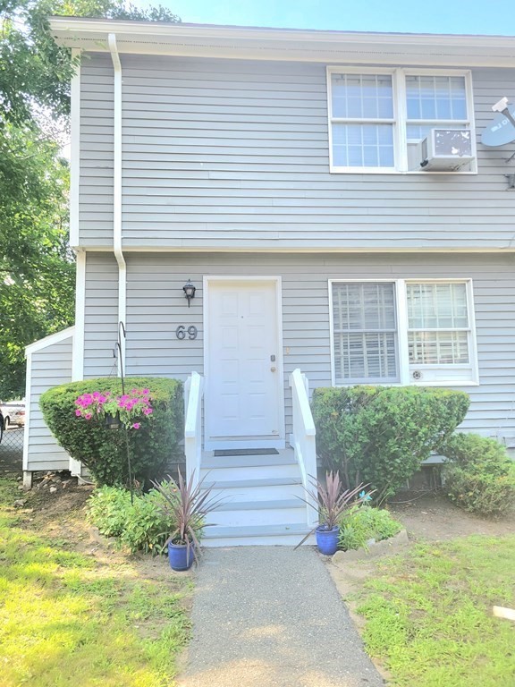 69 Fuller Street, Unit 69 Boston, MA 02124 - Photo 2 of 18 a front view of a house with garden