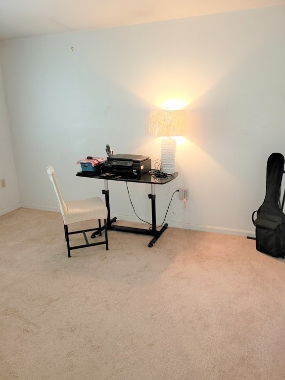 69 Fuller Street, Unit 69 Boston, MA 02124 - Photo 6 of 18 a room with table and chair