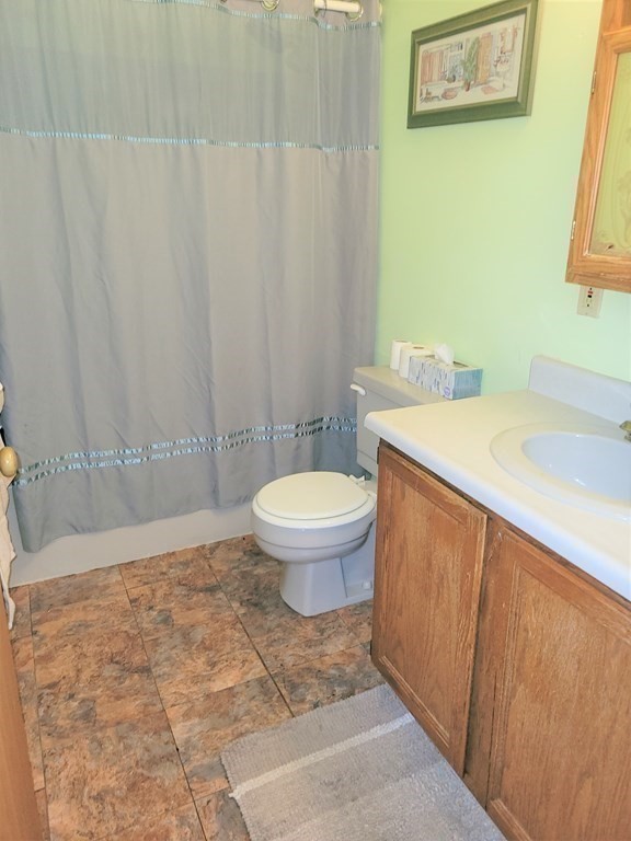 69 Fuller Street, Unit 69 Boston, MA 02124 - Photo 7 of 18 a bathroom with a sink a toilet and a mirror