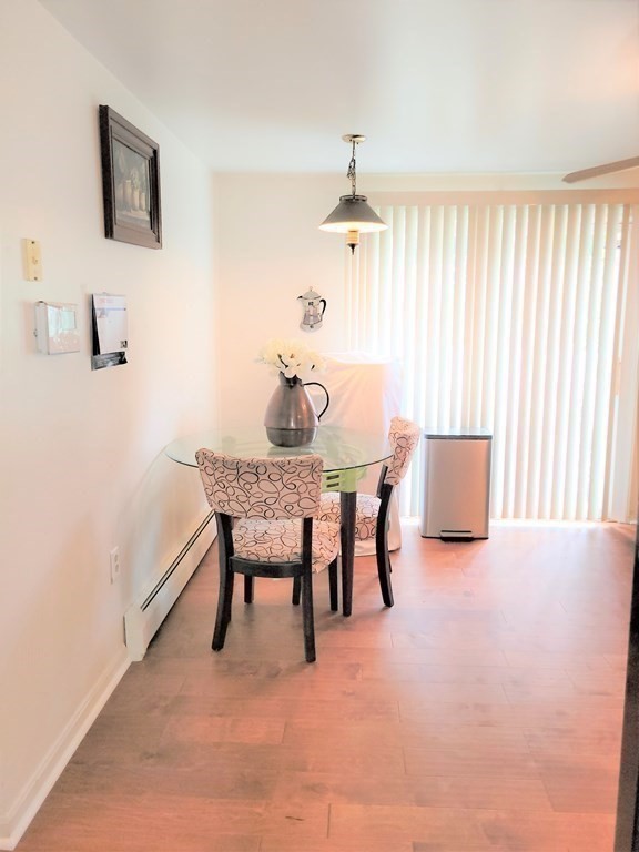 69 Fuller Street, Unit 69 Boston, MA 02124 - Photo 9 of 18 a dining room with furniture and window