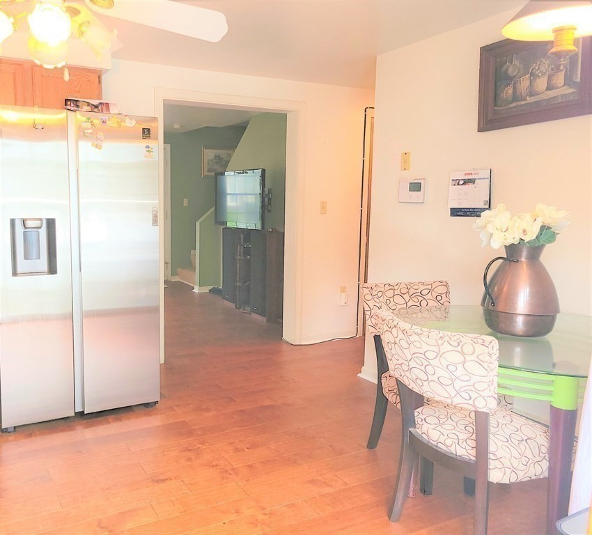 69 Fuller Street, Unit 69 Boston, MA 02124 - Photo 10 of 18 a dining room with furniture and chandelier