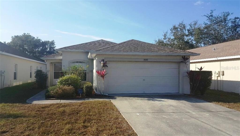 16640 Caracara Court Spring Hill, FL 34610 - Photo 1 of 1 a front view of house with garage