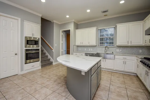 a kitchen with a sink cabinets and appliances