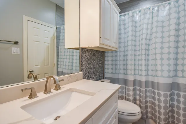 a bathroom with a sink vanity and a mirror