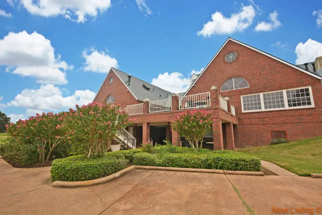 a view of a tennis ground with a small pool