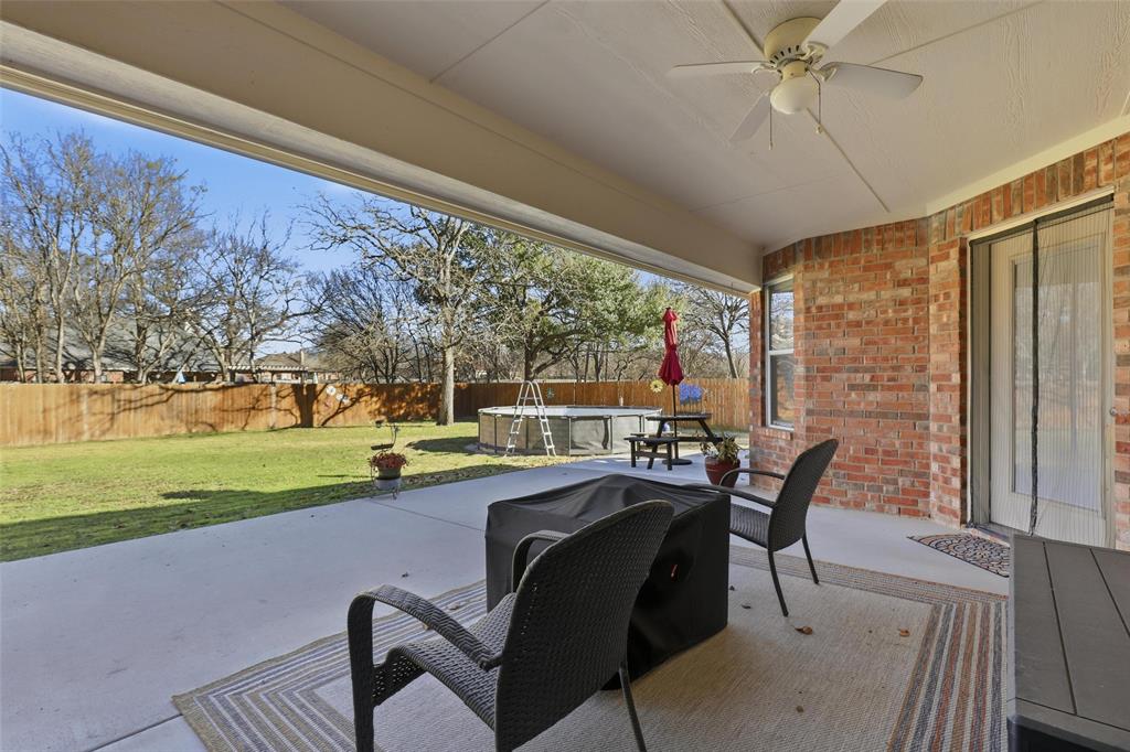 3207 Crossbridge Circle Granbury, TX 76049 - Photo 25 of 29 a view of a patio with table and chairs and couches with wooden floor and fence