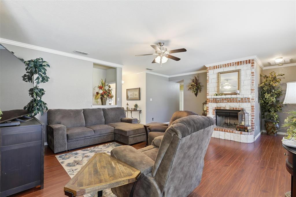 3207 Crossbridge Circle Granbury, TX 76049 - Photo 7 of 29 a living room with furniture a fireplace with wooden floor