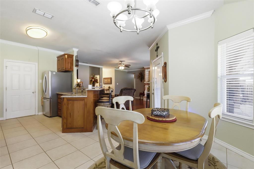 3207 Crossbridge Circle Granbury, TX 76049 - Photo 10 of 29 a dining room with furniture a window and kitchen view