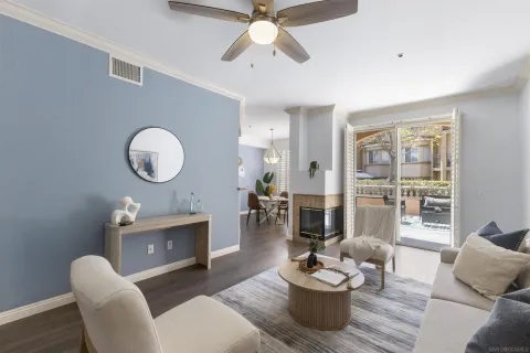 a living room with furniture a fireplace and a large window