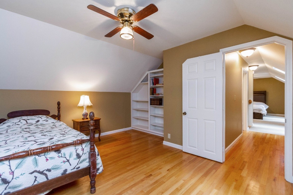 161 Curlicue Road Sewanee, TN 37375 - Photo 15 of 50 a bedroom with a bed and a chandelier