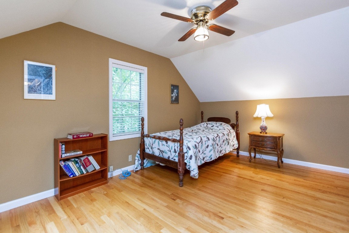161 Curlicue Road Sewanee, TN 37375 - Photo 16 of 50 a bedroom with a bed and wooden floor