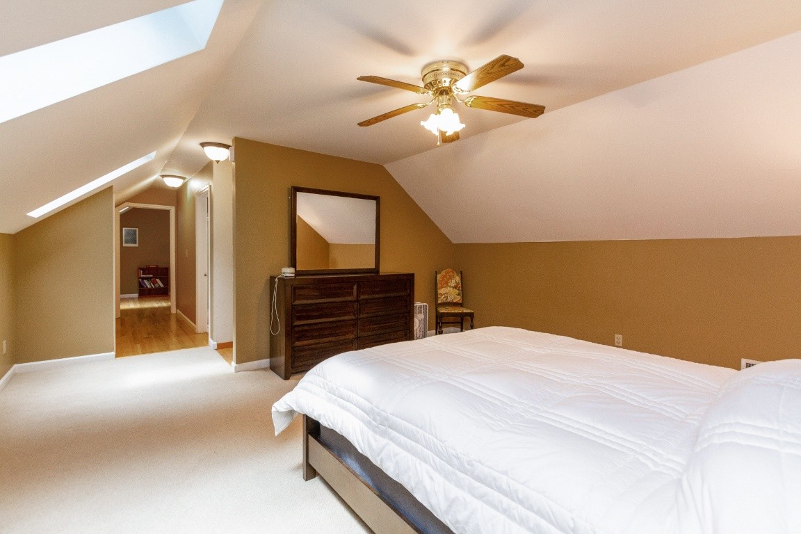 161 Curlicue Road Sewanee, TN 37375 - Photo 17 of 50 a bedroom with a bed and a chandelier