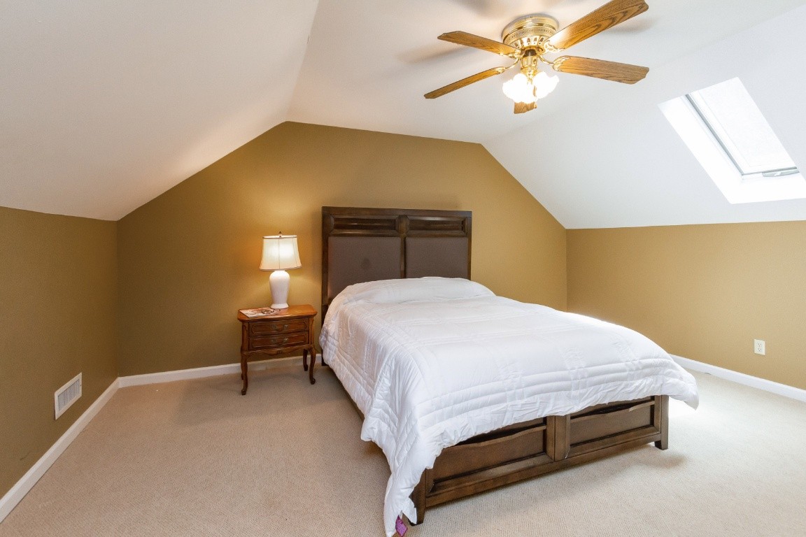 161 Curlicue Road Sewanee, TN 37375 - Photo 18 of 50 a bedroom with a bed and a chandelier