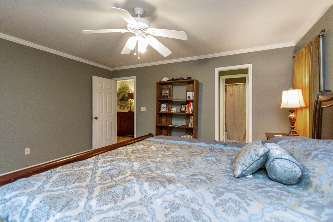 161 Curlicue Road Sewanee, TN 37375 - Photo 22 of 50 a bedroom with a large bed and a chandelier