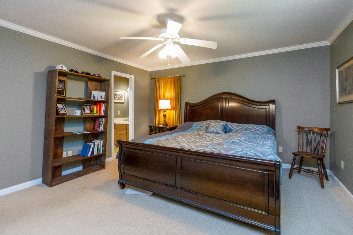 161 Curlicue Road Sewanee, TN 37375 - Photo 23 of 50 a bedroom with a bed and a chandelier