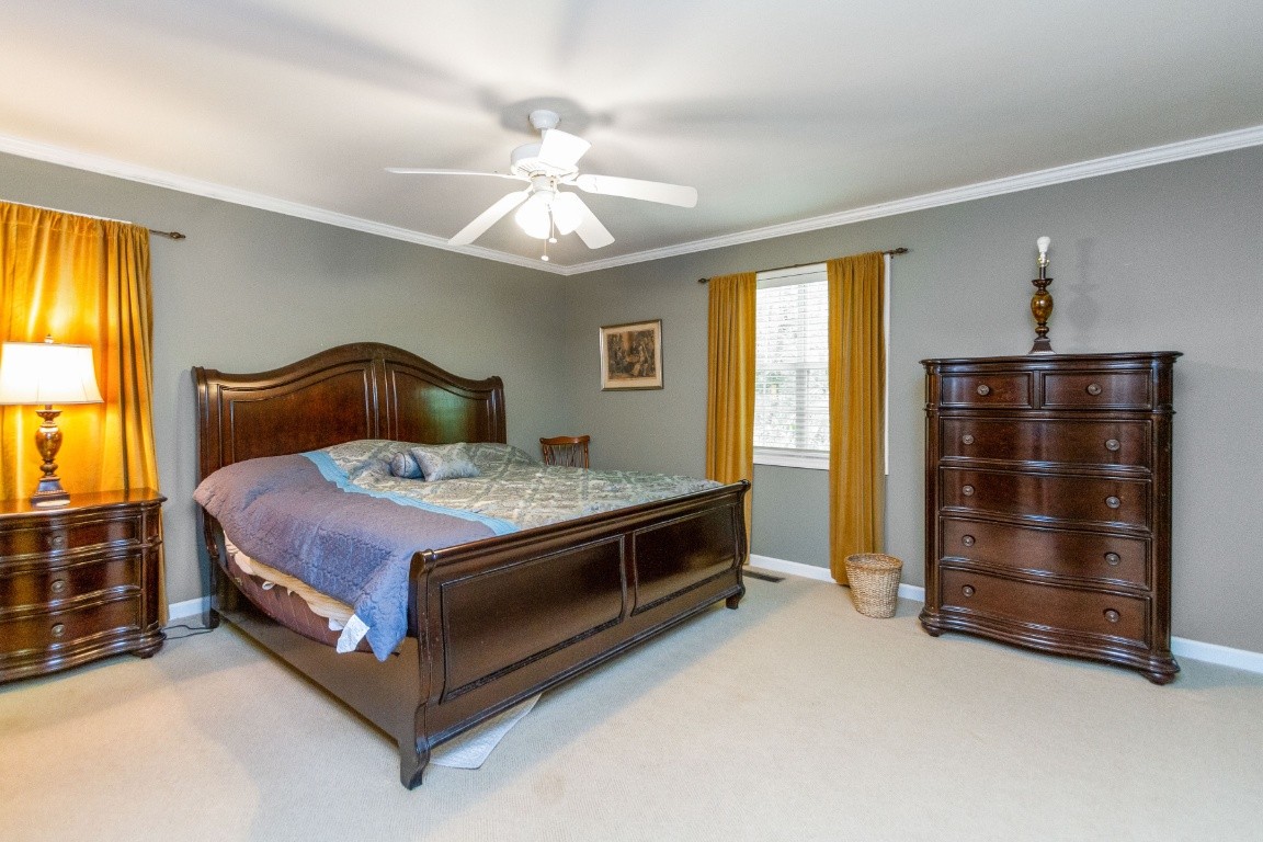 161 Curlicue Road Sewanee, TN 37375 - Photo 24 of 50 a bedroom with a bed and a chandelier