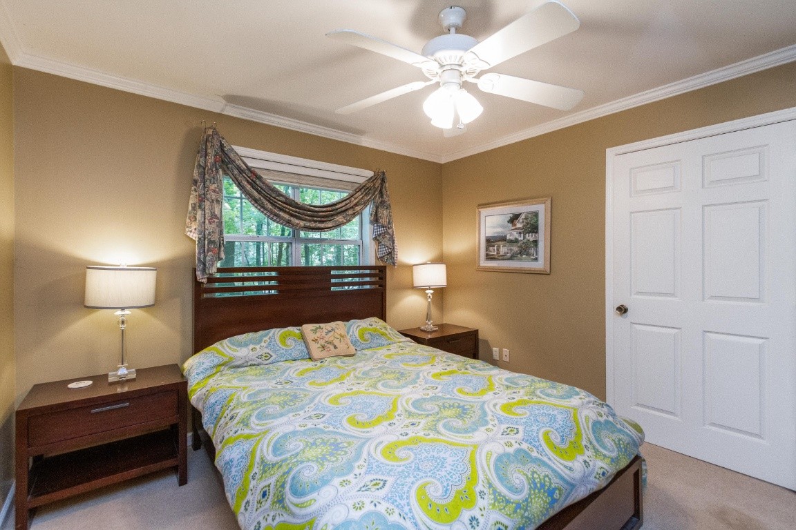 161 Curlicue Road Sewanee, TN 37375 - Photo 26 of 50 a bedroom with a bed and a lamp on dresser