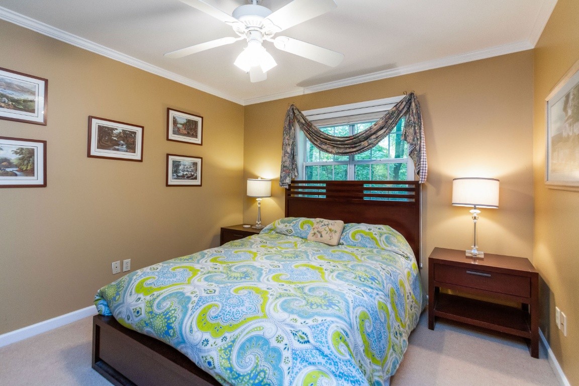 161 Curlicue Road Sewanee, TN 37375 - Photo 28 of 50 a bedroom with a bed and a chandelier