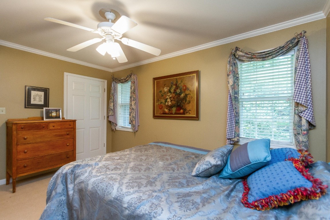 161 Curlicue Road Sewanee, TN 37375 - Photo 30 of 50 a bedroom with a bed and a chandelier