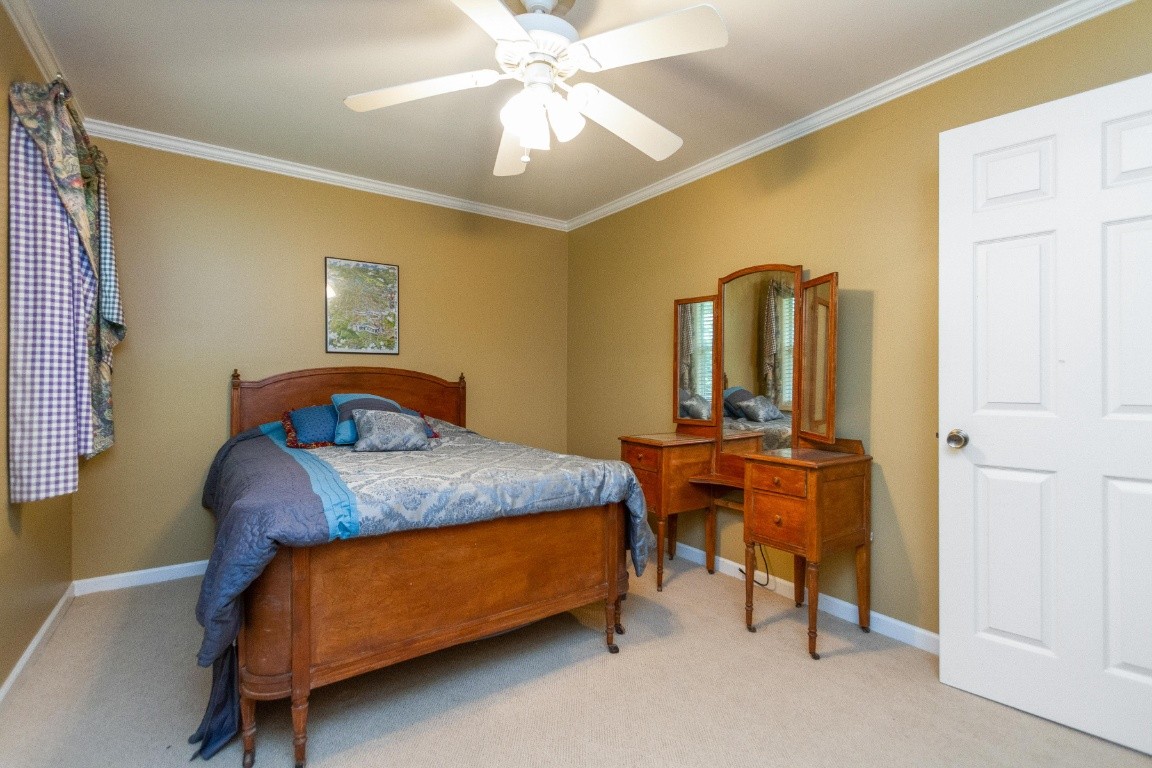 161 Curlicue Road Sewanee, TN 37375 - Photo 31 of 50 a bedroom with a bed and a chandelier