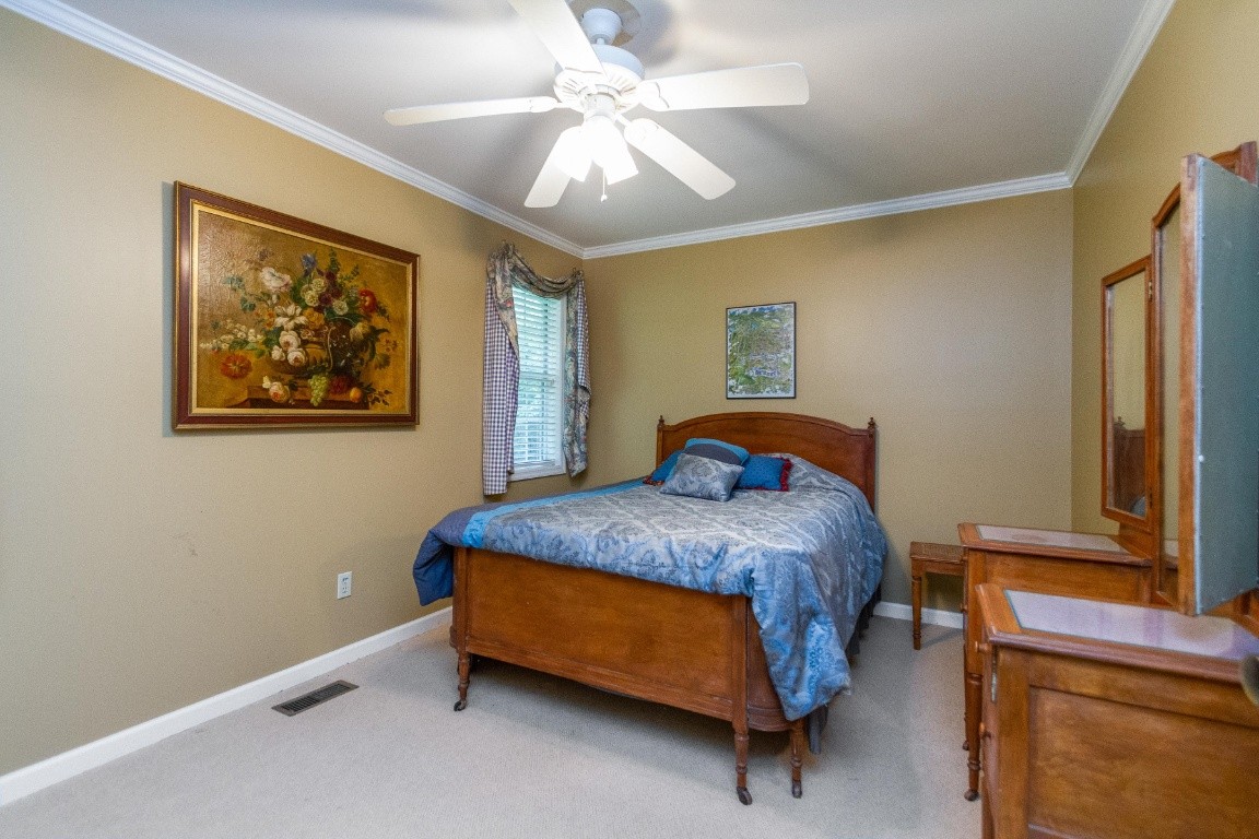 161 Curlicue Road Sewanee, TN 37375 - Photo 32 of 50 a bedroom with a bed and a painting on the wall