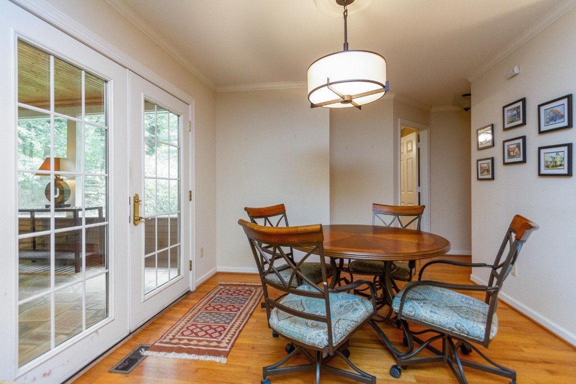 161 Curlicue Road Sewanee, TN 37375 - Photo 33 of 50 a dining room with furniture a chandelier and wooden floor