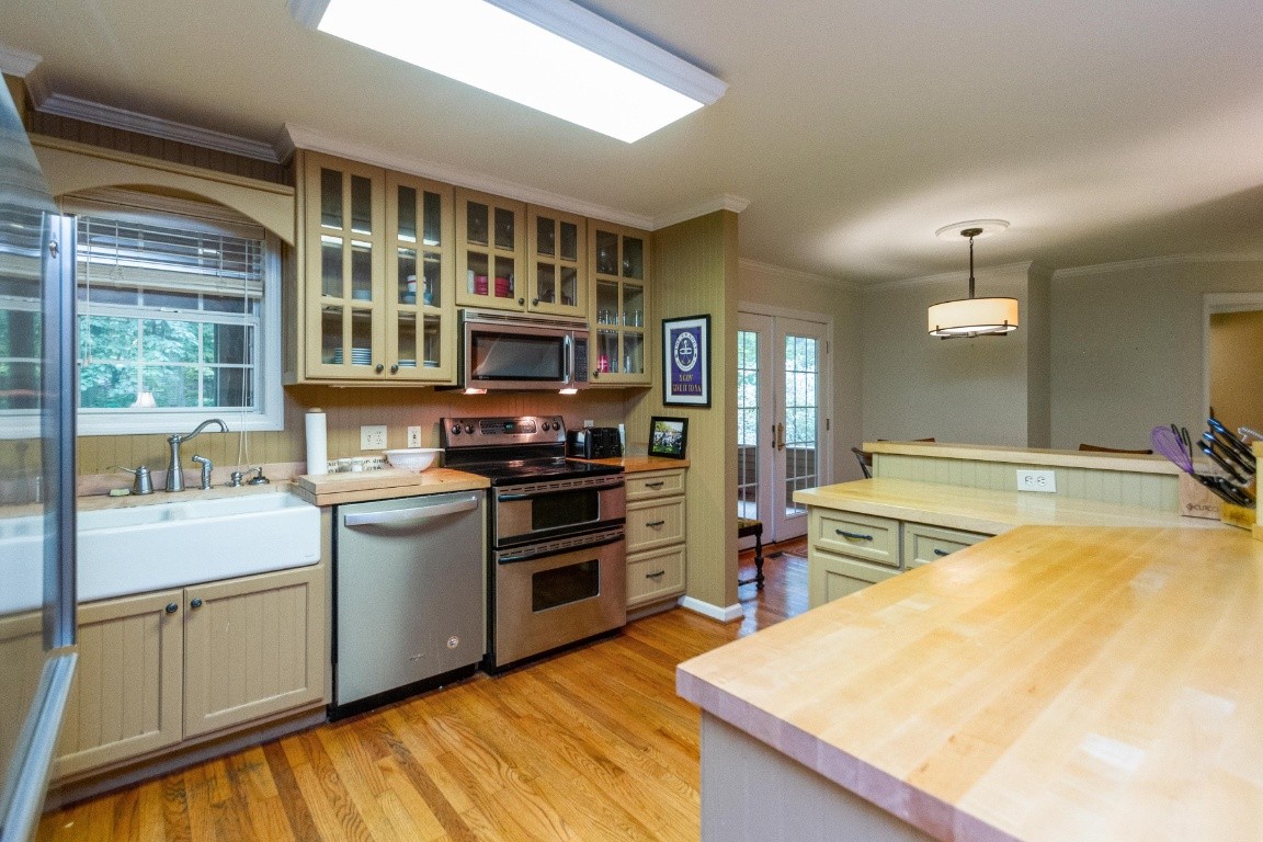 161 Curlicue Road Sewanee, TN 37375 - Photo 39 of 50 a kitchen with stainless steel appliances kitchen island a large stove a refrigerator and a stove